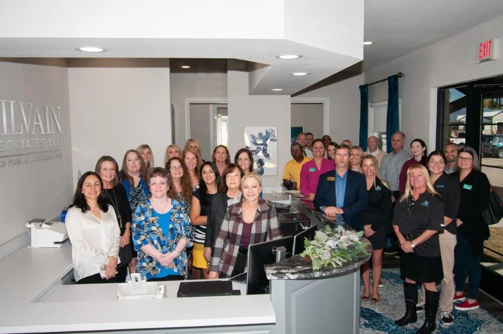 McIlvain team gathered at a ribbon cutting event